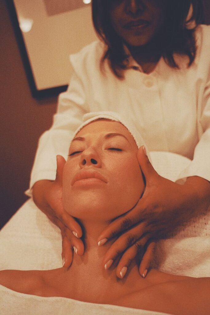 Close-up of a woman receiving a relaxing facial massage, enhancing wellness and tranquility.